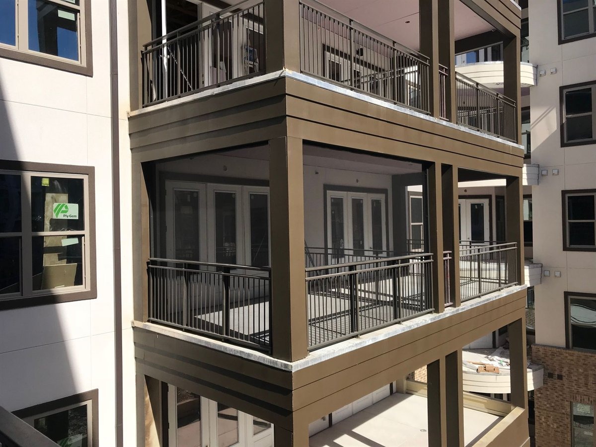 A1 crew member reviewing patio cover drawings on a job site in Austin