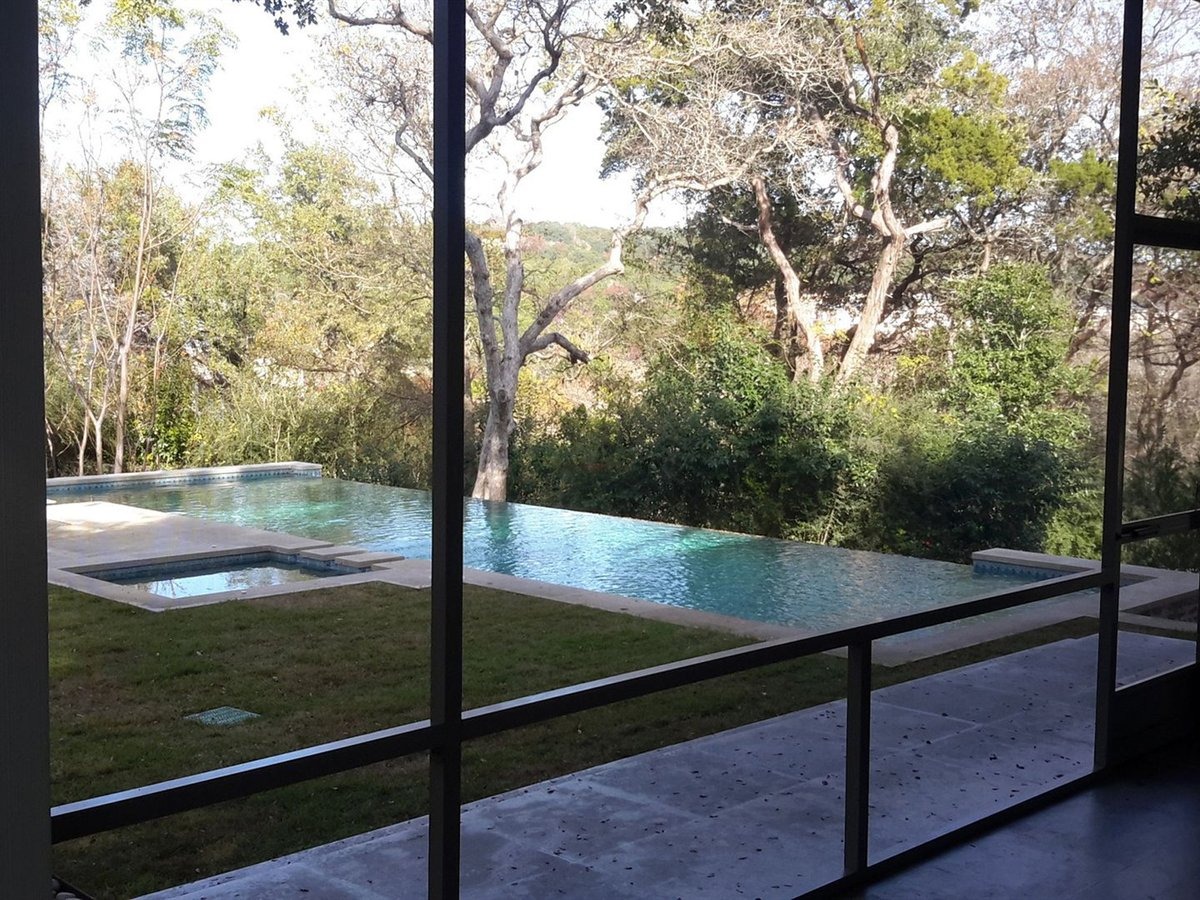 Detail of screen room framing, kick plate and screen door on an Austin patio