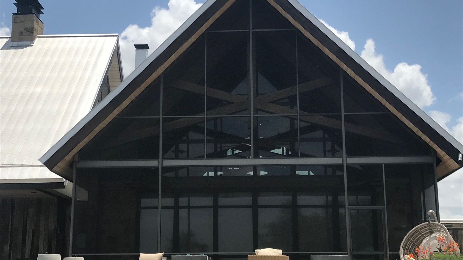 Family relaxing under a new insulated aluminum patio cover in Austin
