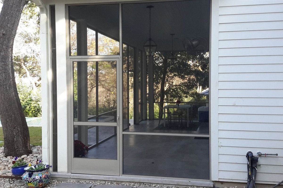 Insulated aluminum patio cover with recessed lighting on an Austin home