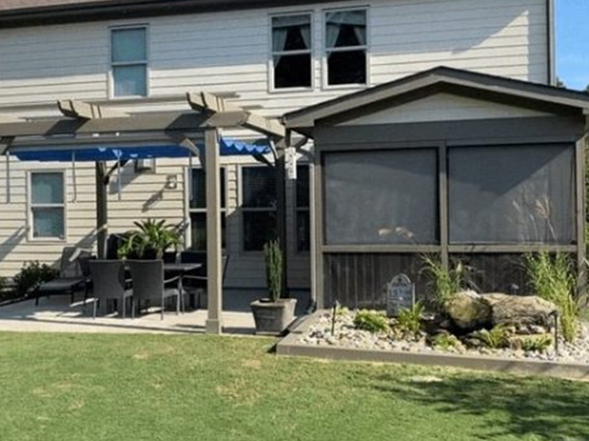 Louvered pergola with louvers open above a pool deck on a Lakeway hillside lot