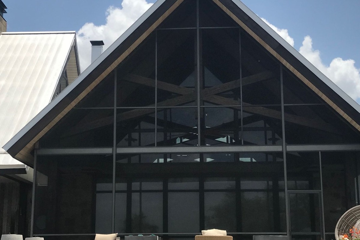 Screened patio enclosure with seating and ceiling fan in Round Rock