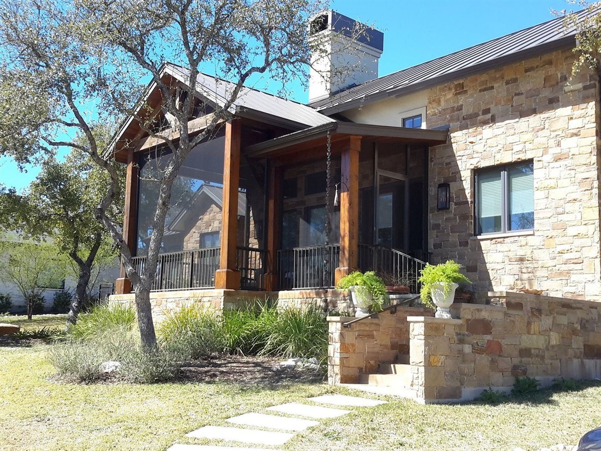 Shaded patio under an insulated aluminum cover on a hot Austin afternoon